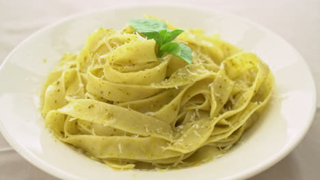 pesto-fettuccine-pasta-with-parmesan-cheese-on-top---Italian-food-style