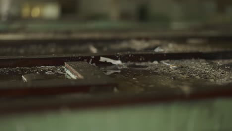 ruined large industrial hall, drops of water fall in puddle on floor