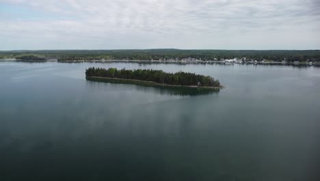 aerial shot of island and lake town, hessel, michigan