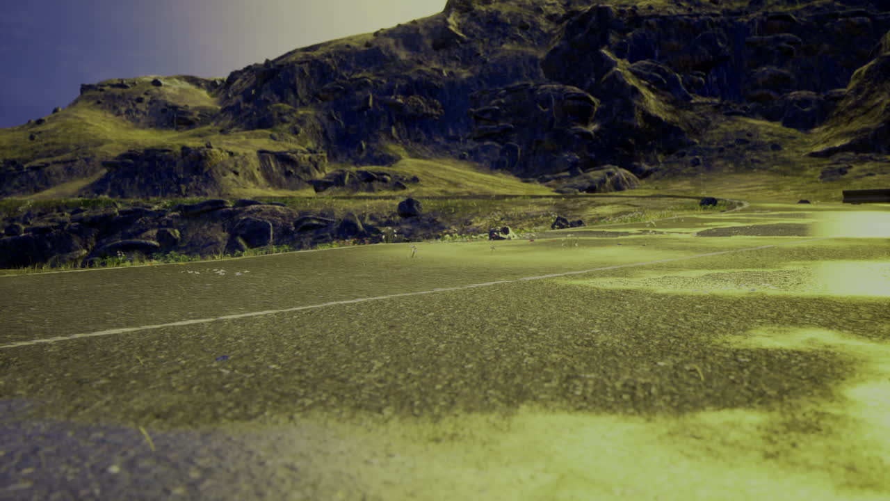 Exploring a desolate road surrounded by rugged mountains during twilight