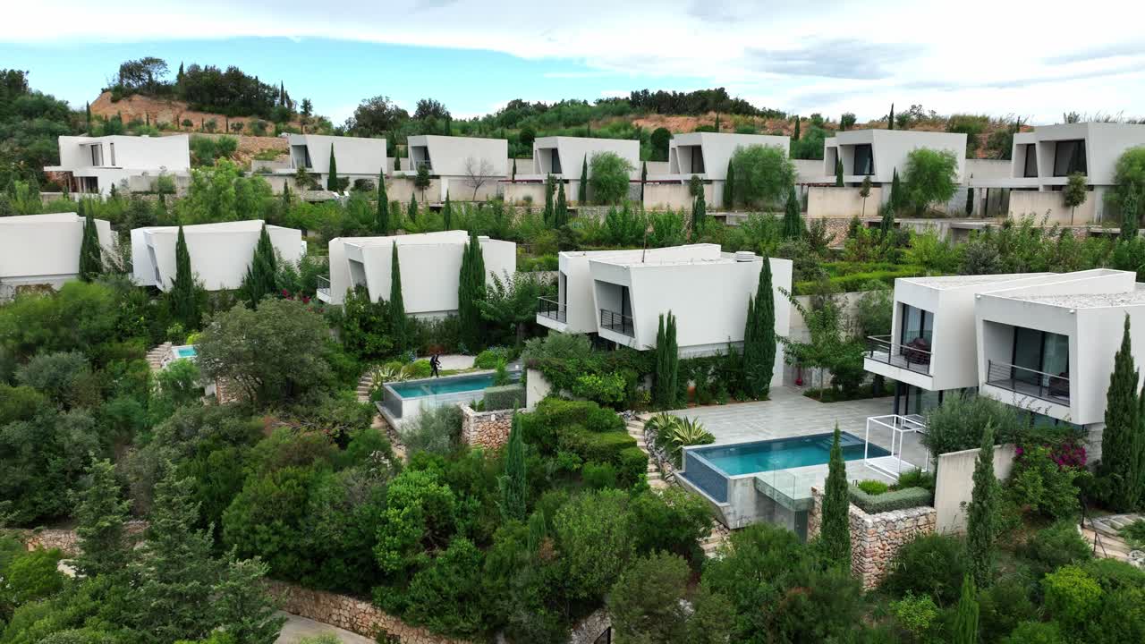 Drone view of a modern housing area with swimming pools