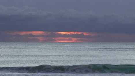 waves splashing on the beach during tropical sunrise in coolangatta, australia.
