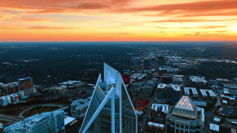 flying above the highest buildings in charlotte, north carolina, usa. amazing pink orange sky over the immense cityscape