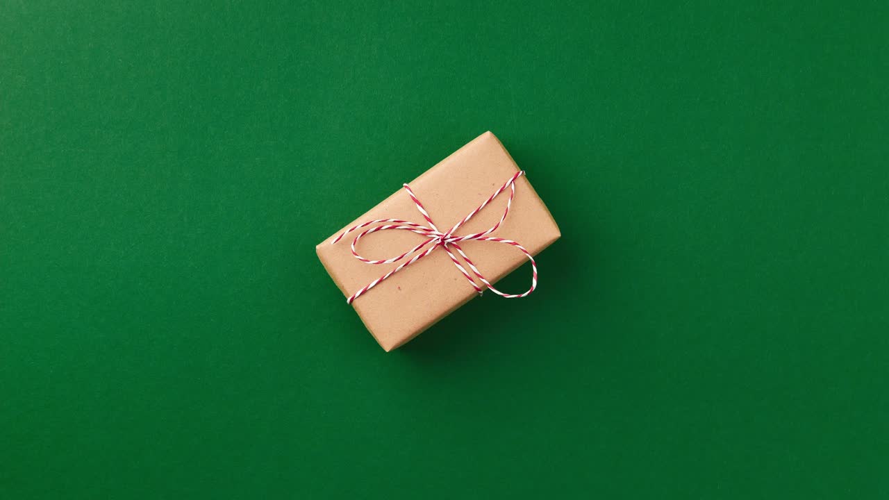 Stop motion animation with Christmas New year gift box moves and turns on green background