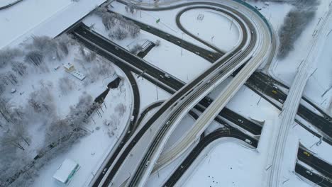 aerial view of a freeway intersection snow-covered in winter.