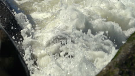 ocean waves breaking on rocky coast, close up full frame slow motion 120fps