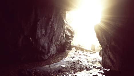 sunlight streaming through a cave opening in a natural landscape