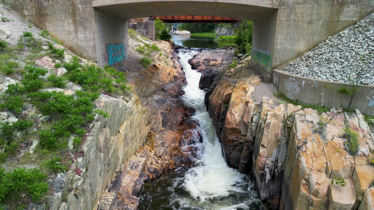 Whitefish Falls aerial fly under bridge, Manitoulin Island, Ontario, Canada