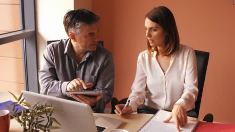 business people discussing over digital tablet