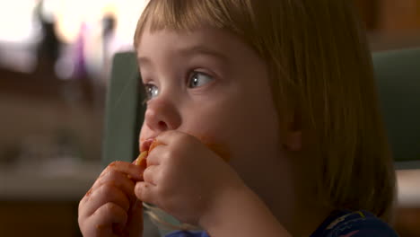 a preschool aged girl eats and plays with her spaghetti