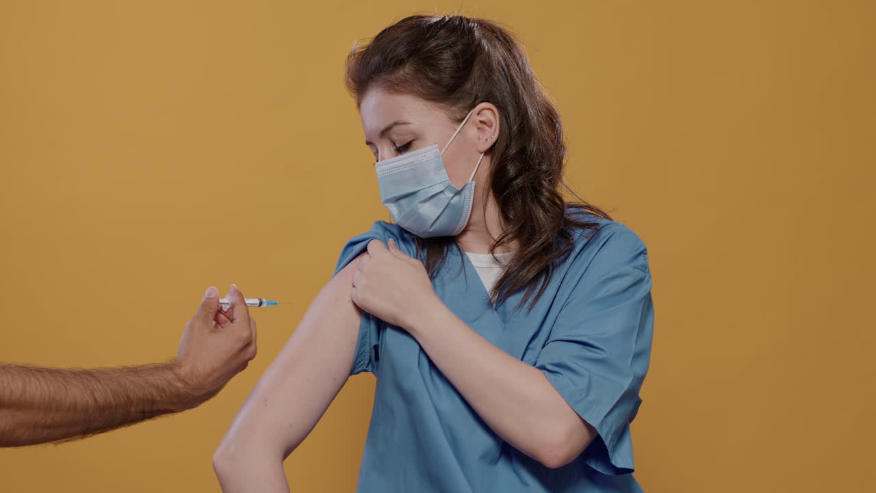 Nurse receiving a vaccine injection