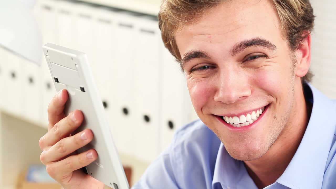 Young man using calculator