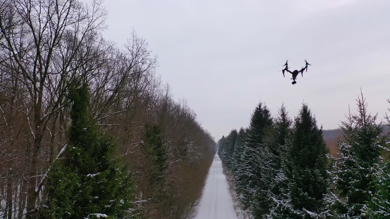 Drone with camera flying high above. Personal drone flying through the air in suburban atmosphere