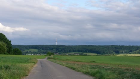 Timelapse-of-cloudy-skies-above-rural-farm-field-outside-of-Stuttgart-in-afternoon,-Baden-Wurttemberg,-Germany,-Europe