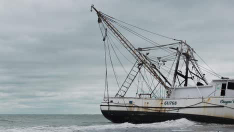 shrimp boat in the ocean on a cloudy day