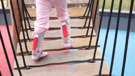 young girl playing on a playground bridge