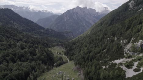 drone video with descriptive frontal shot over the vrsc pass in slovenia with mountains on the horizon