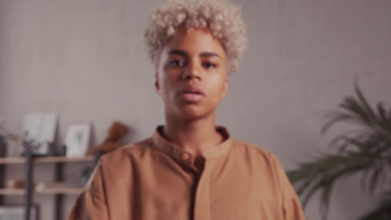 African woman does stop sign with palm demonstrates prohibition and restriction