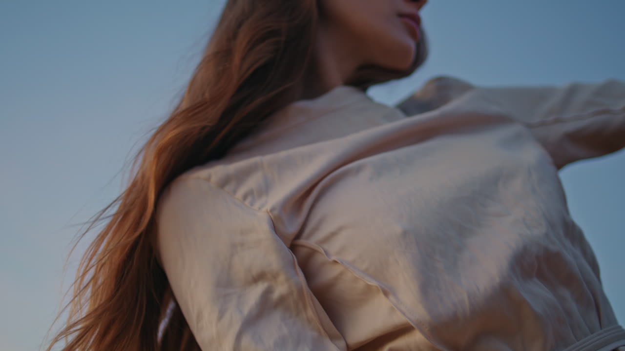 편안한 여자가 감각적으로 춤을 추고 자연의 근접에 손을 흔들고 공연자가 움직입니다.