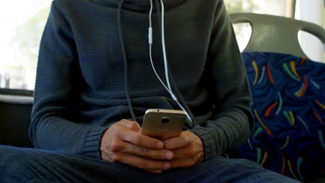 male commuter using mobile phone while travelling in bus 4k