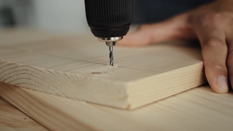 close up video of drilling on wood plate