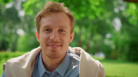 happy man posing on picnic close up. portrait of blond guy looking on camera.