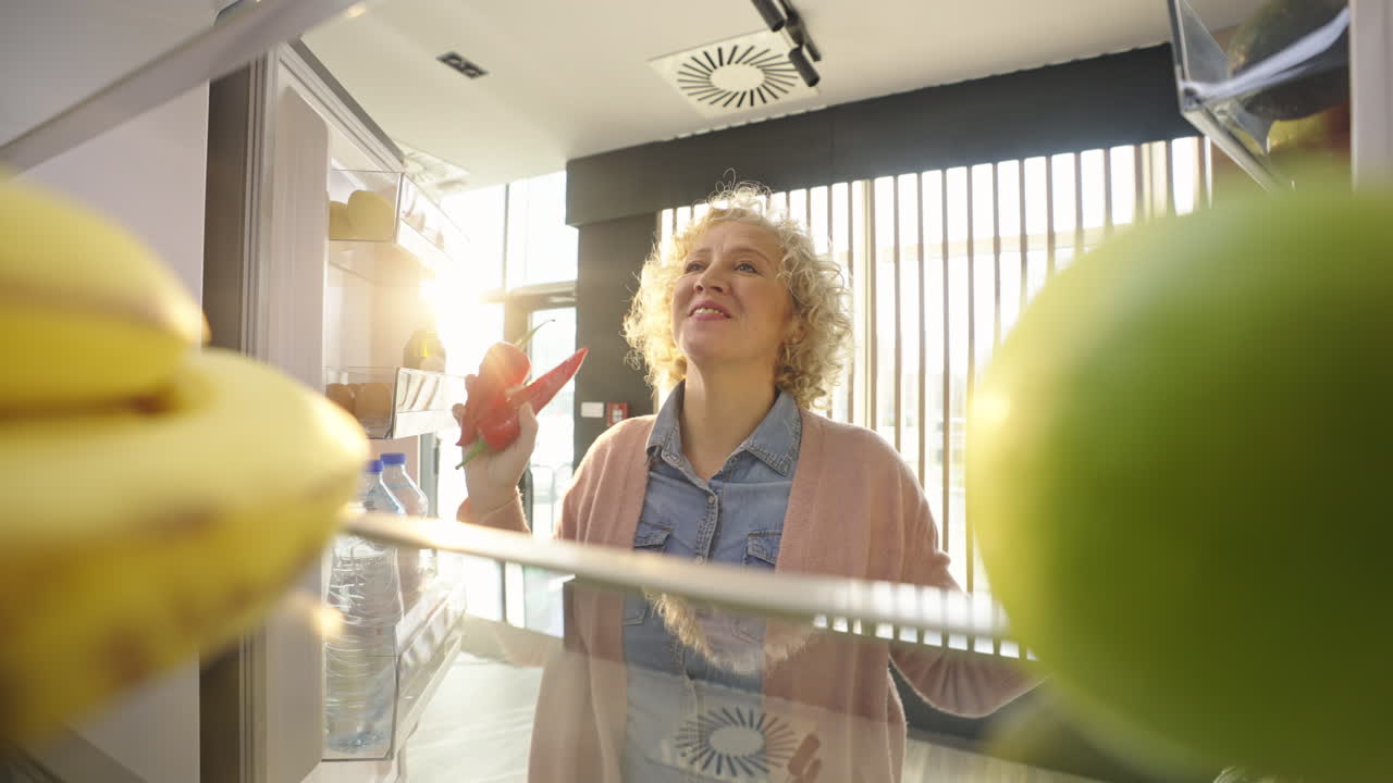 Woman taking food out of the refrigerator
