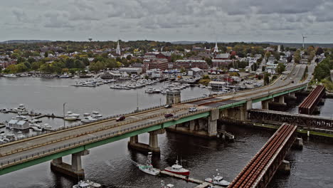 Newburyport-Massachusetts-Aerial-v8-flyover-bridge-road-towards-downtown-area-with-traffic-crossing-over-merrimack-river,-capturing-historic-townscape---Shot-with-Inspire-2,-X7-camera---October-2021