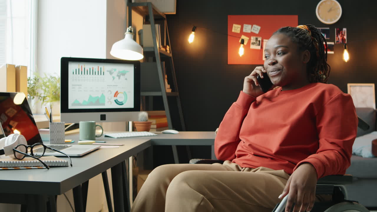 African American Woman in Wheelchair Talking on Phone