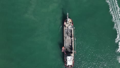 a large industrial dredging vessel pumping tons of sand into the ships storage area for a coastal rejuvenation project