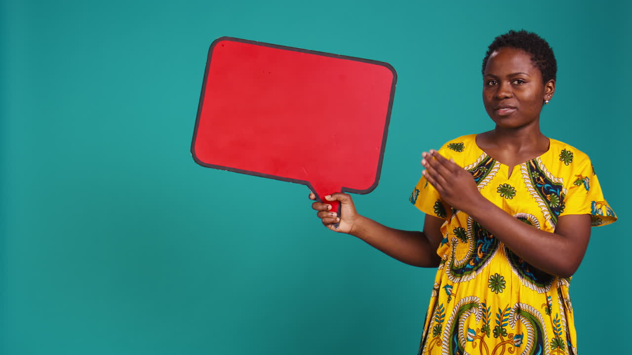 Woman in ethnic clothes holds a speech bubble carton board