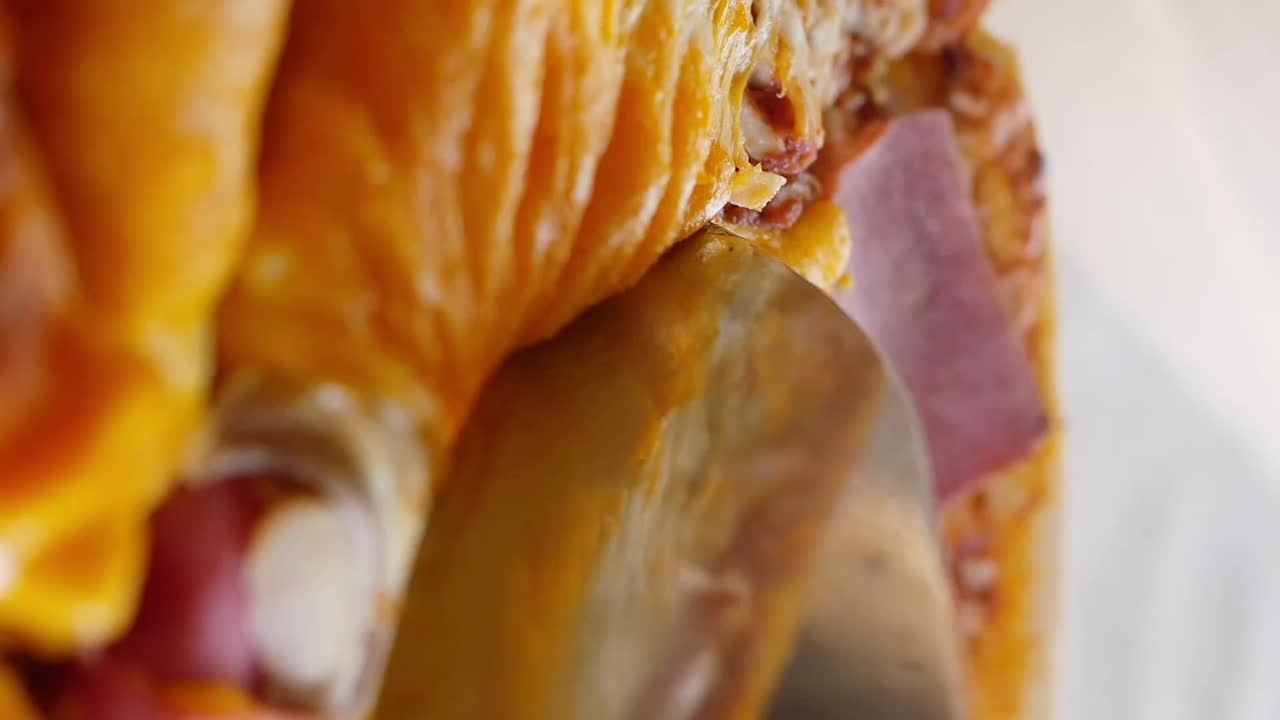 Close-up of a sandwich with ham, bacon, and cheese
