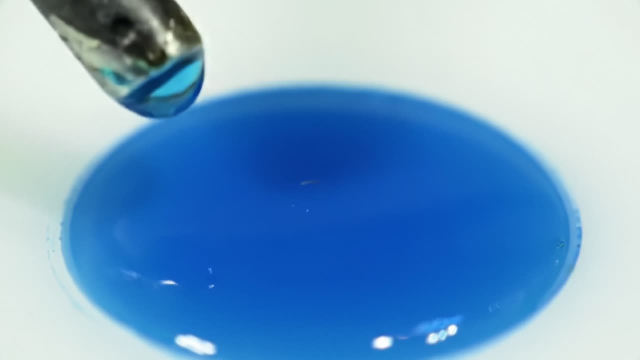 Capturing the Vivid Transition of Blue Liquid: A Study in Color and Fluid Dynamics Through Macro Photography of a Glossy Substance