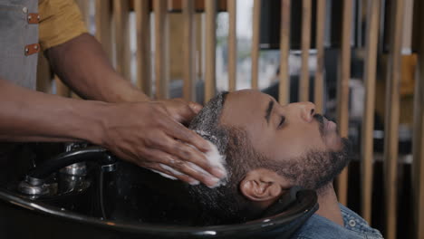 man getting his hair washed at a barbershop