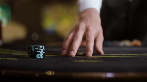 croupier collecting poker chips.