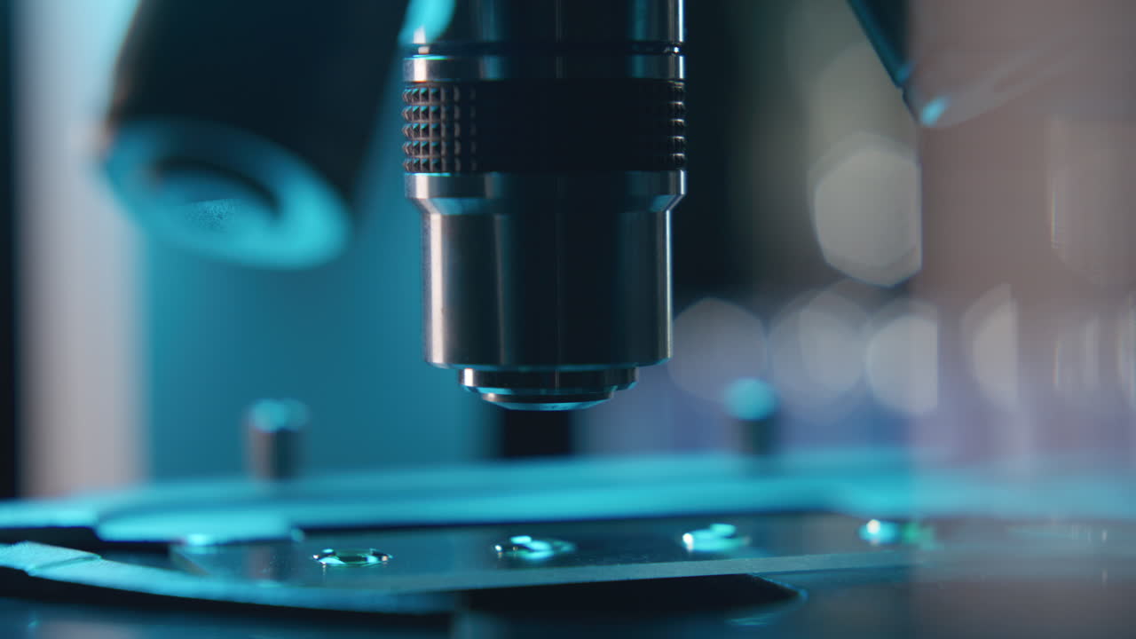 Adjusting Slide with Droplets under Laboratory Microscope during Examination