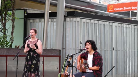 two musicians performing together on a balcony