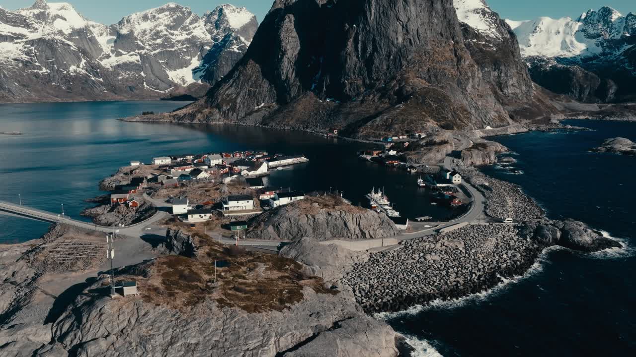 Villas At Reine Village With Lofoten Mountain Peaks In Moskenes Municipality, Nordland County, Norway. Aerial Drone Shot