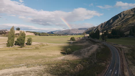 rainbow over a rural valley landscape
