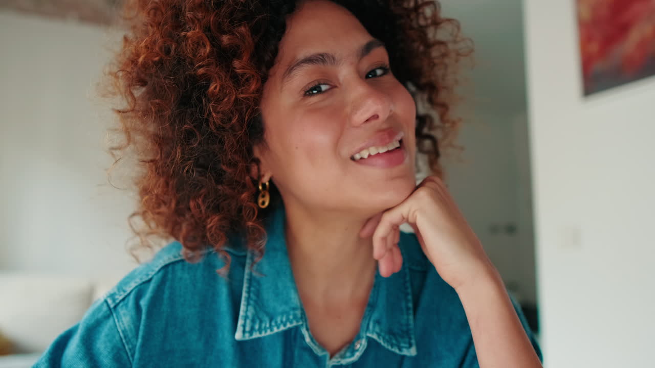 Happy Young Woman with Curly Hair Smiling and Talking on Video Call