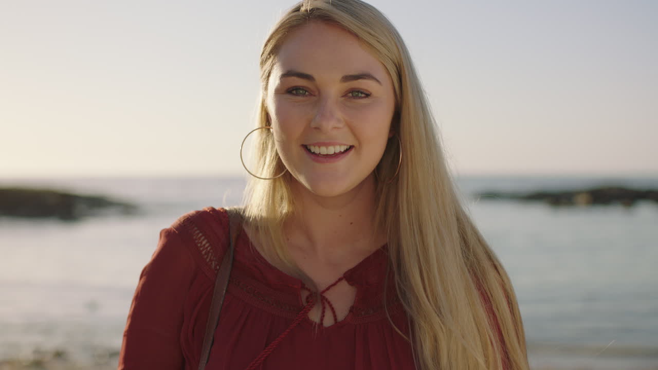 close up portrait of lovely young blonde woman smiling cheerful on sunny morning beach feeling positive