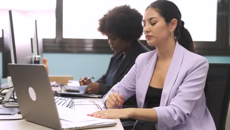 tired businesswoman working on project in office