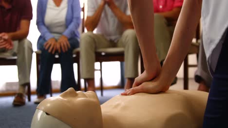 doctor performing resuscitation training on a dummy