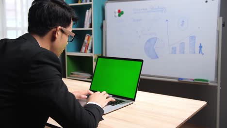 Businessman Working With Green Screen Laptop