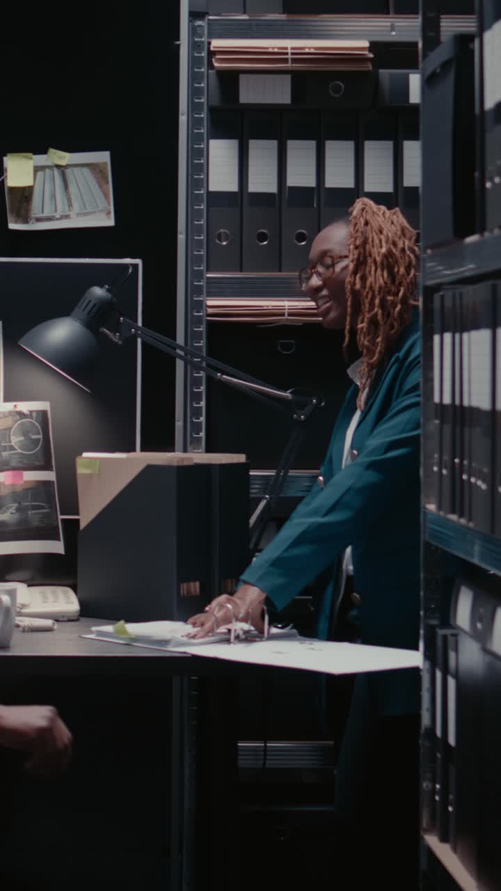 Vertical video: Detective inspectors doing background checks in archive