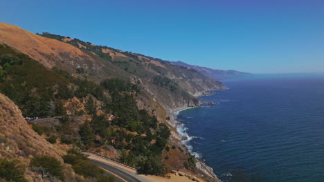 Splendid scenery of mountains meeting the ocean. Roads in the rocks among the pine trees. Big Sur Morro Bay in California, USA.