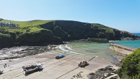 High-level-view-of-fishing-boats-beached-in-harbour-at-low-tide-on-sunny-day