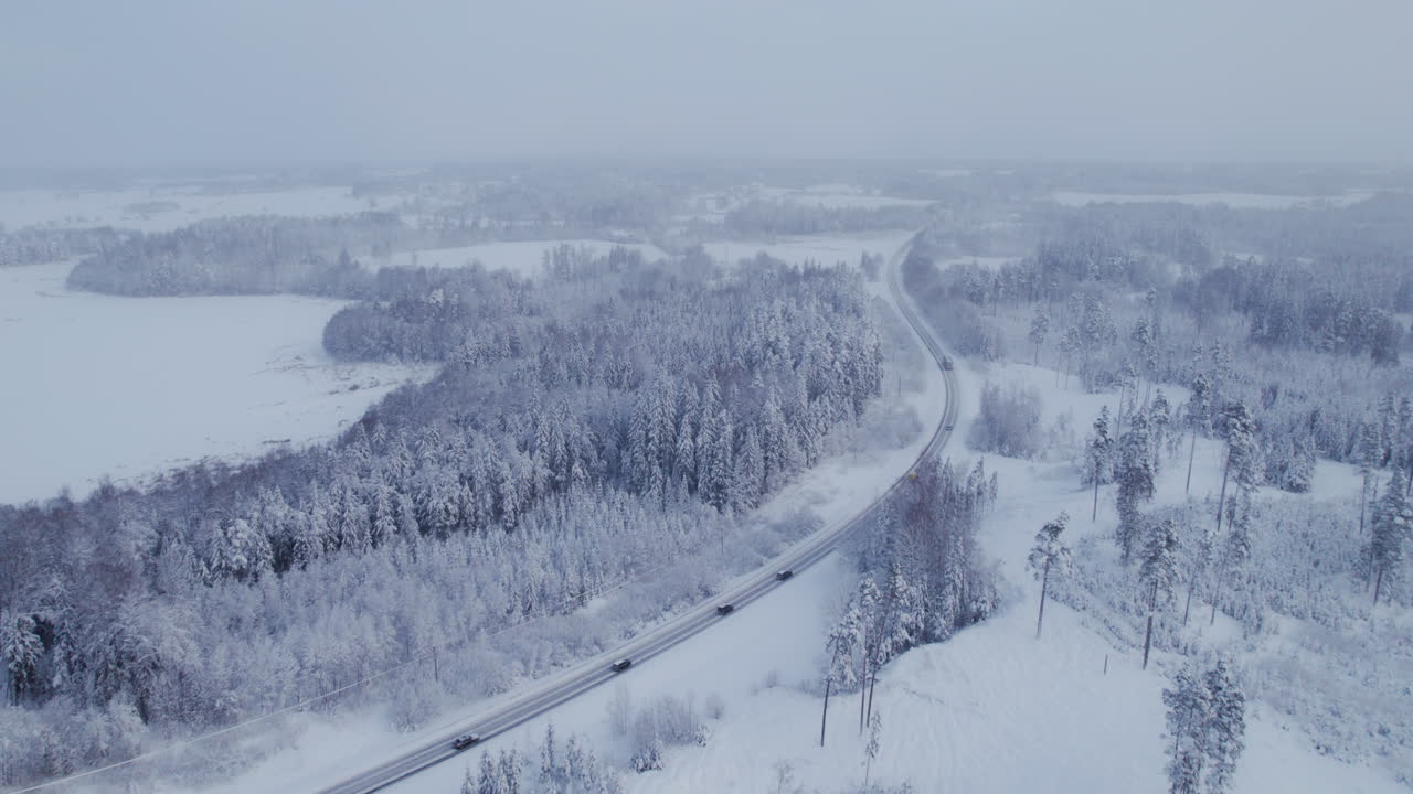 4k 지역의 아름다운 전망, 눈이 내리는 동안 눈과 얼음으로 덮인 고속도로 위를 비행하는 드론