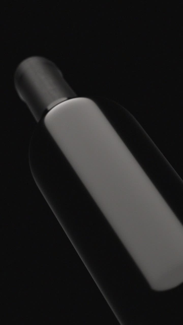 Elegant Wine Bottle with Moving Light Reflection on Dark Background