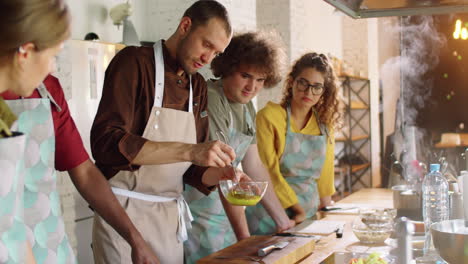 chef mixing ingredients while giving cooking master class